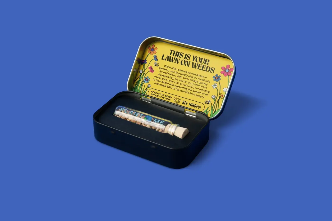 An open seed tin with a glass seed tube inside, on a deep blue background