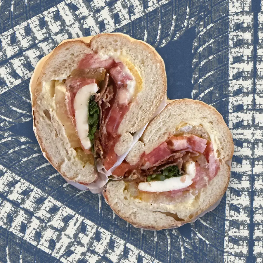 The Dream Tomato Sandwich, photographed in cross-section and floated over a riso print of the Austin skyline.